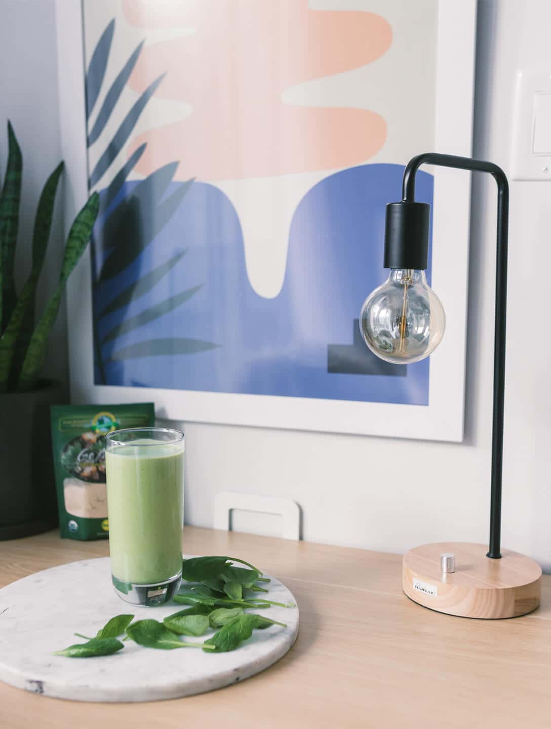 A basil smoothie on a desk
