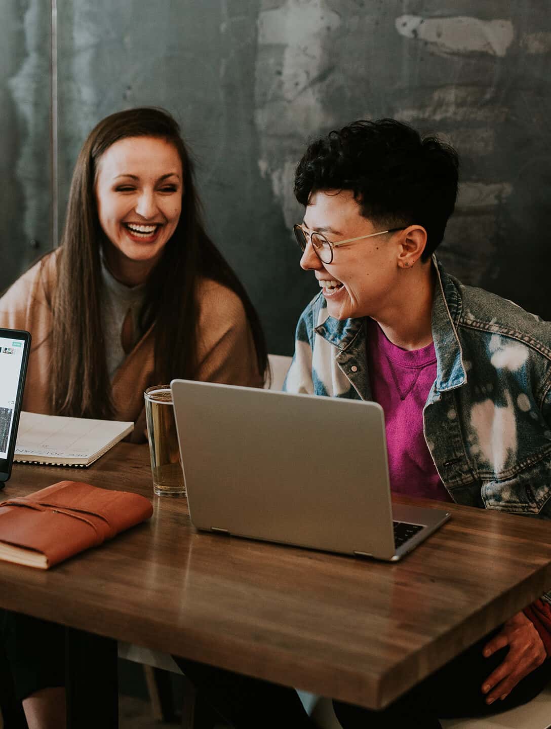 Two people laughing while they work